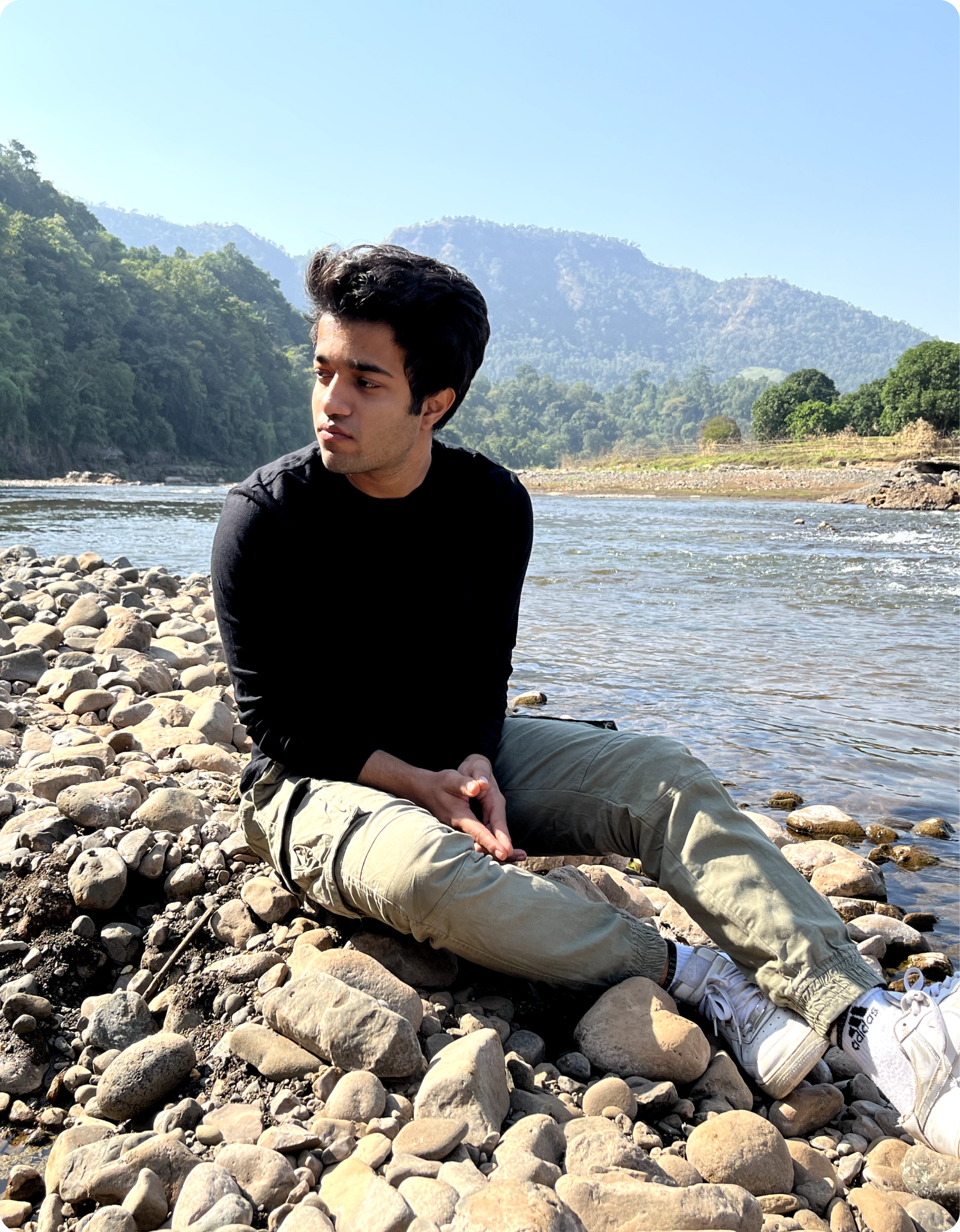 Atharva sitting by a river